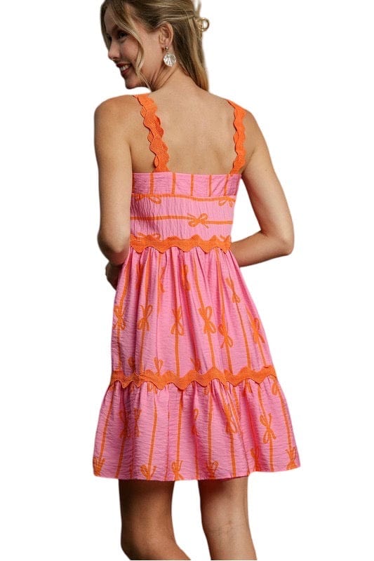 Pink and orange bow tiered dress with ric rac trim