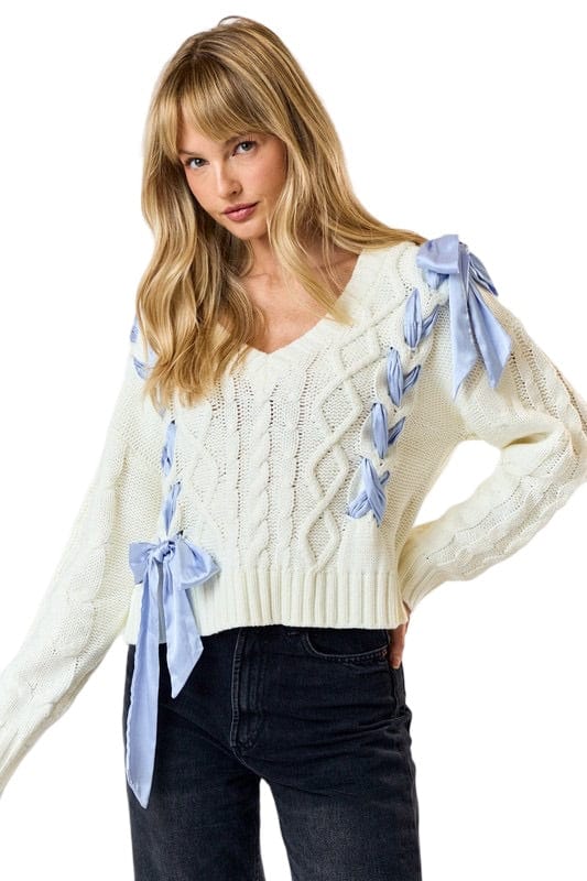 Cream knit sweater with blue ribbon