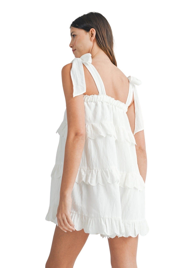 White ruffled tiered romper with scalloped trim
